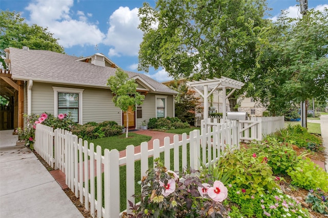 view of front facade with a pergola and a front yard