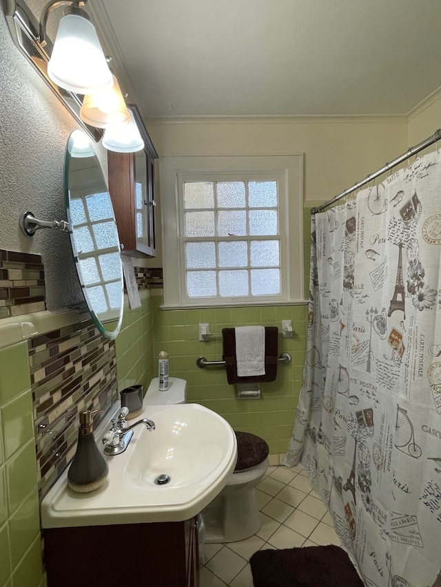 bathroom featuring tasteful backsplash, tile patterned floors, crown molding, toilet, and vanity