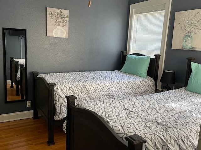 bedroom with hardwood / wood-style flooring