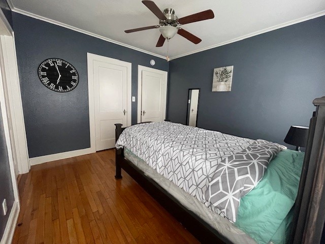 bedroom with ceiling fan, dark hardwood / wood-style floors, and ornamental molding