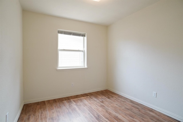 empty room with light hardwood / wood-style flooring