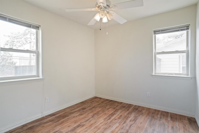 spare room featuring ceiling fan, light hardwood / wood-style floors, and a wealth of natural light