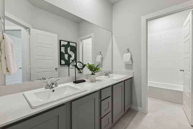 bathroom with washtub / shower combination, tile patterned floors, and vanity