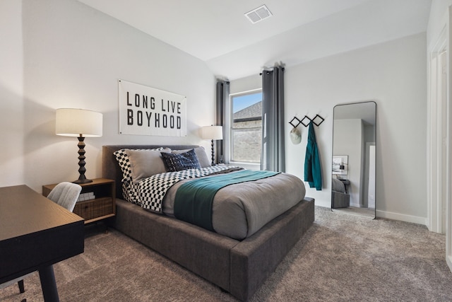 carpeted bedroom with lofted ceiling