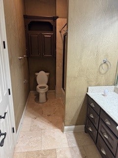 bathroom featuring vanity, toilet, and a shower with door