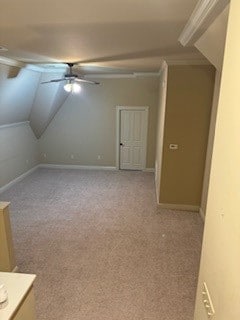 bonus room with ceiling fan, light carpet, and vaulted ceiling