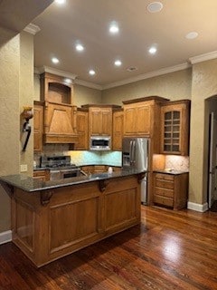 kitchen featuring kitchen peninsula, dark hardwood / wood-style flooring, stainless steel appliances, and a breakfast bar area