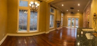 interior space featuring dark hardwood / wood-style flooring, crown molding, plenty of natural light, and ceiling fan with notable chandelier