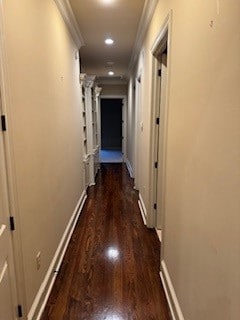 corridor with dark wood-type flooring and ornamental molding