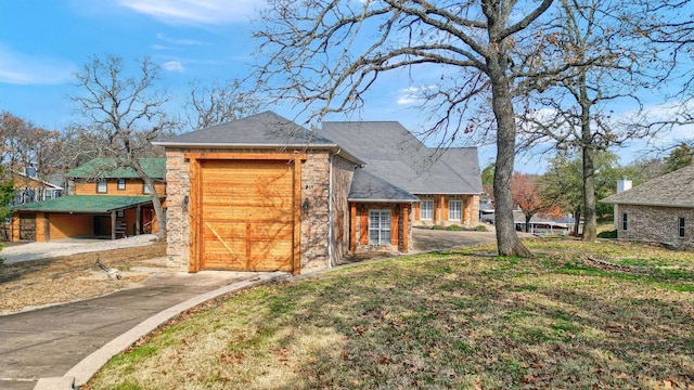 view of front of house featuring a garage and a front lawn