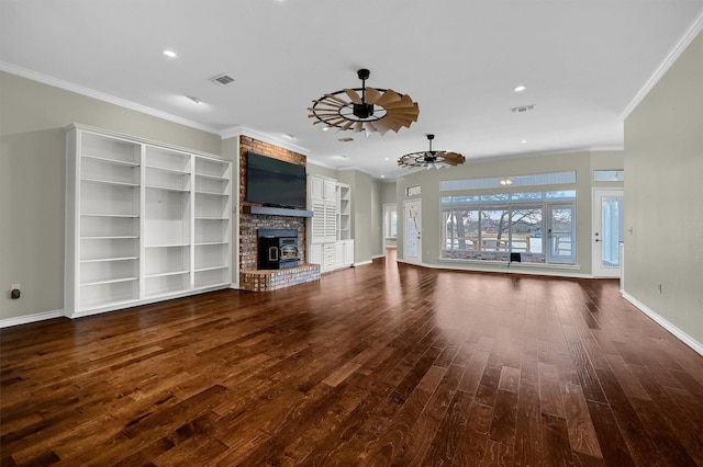 unfurnished living room featuring crown molding, ceiling fan, dark hardwood / wood-style flooring, and a brick fireplace