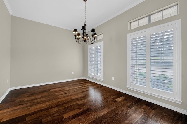 spare room featuring ornamental molding, dark hardwood / wood-style floors, and a notable chandelier