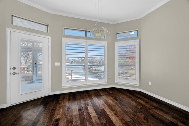 unfurnished dining area with ornamental molding, dark hardwood / wood-style floors, and a notable chandelier