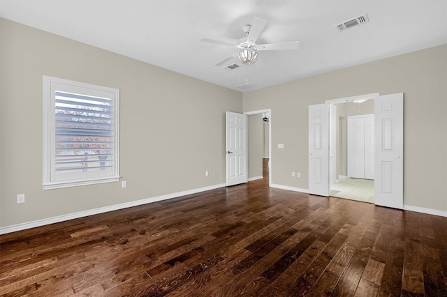 unfurnished bedroom featuring dark hardwood / wood-style floors and ceiling fan