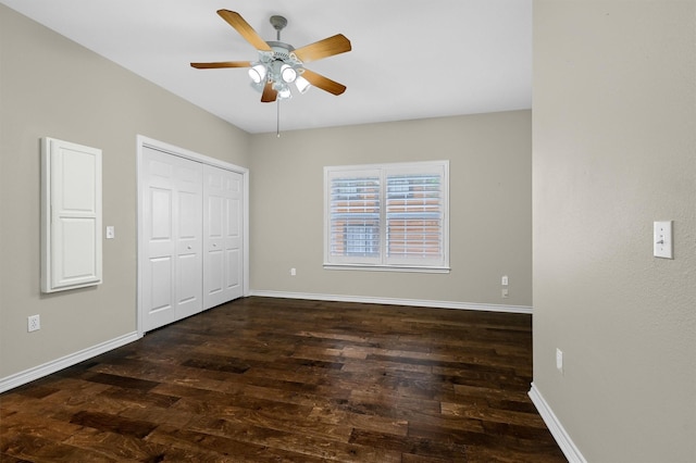 unfurnished bedroom with ceiling fan, dark hardwood / wood-style flooring, and a closet