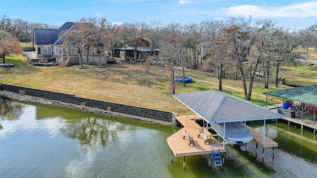 dock area with a water view and a yard