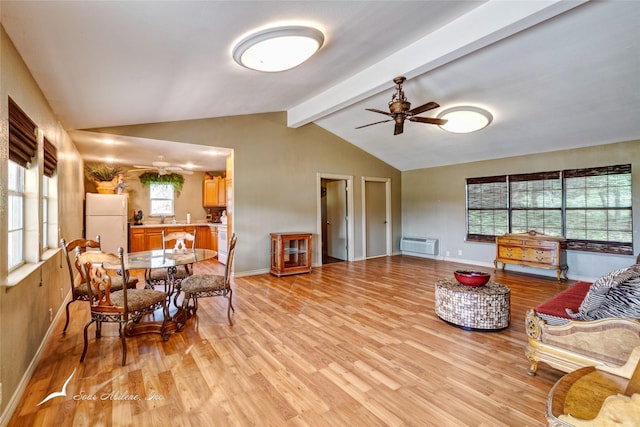 living room with lofted ceiling with beams, an AC wall unit, ceiling fan, and light wood-type flooring