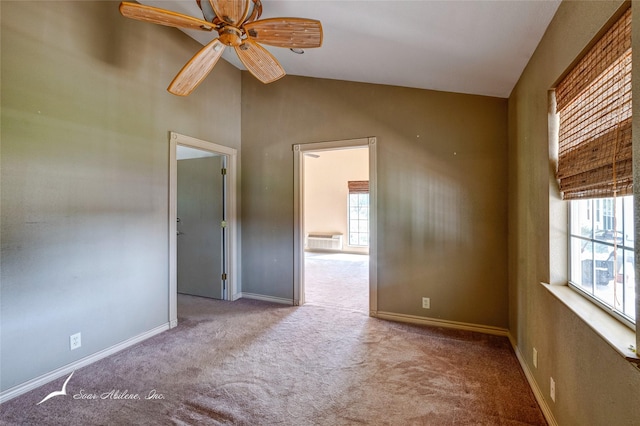 carpeted empty room featuring lofted ceiling and ceiling fan