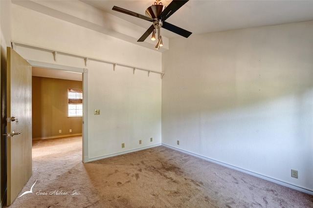 unfurnished room with ceiling fan and carpet flooring