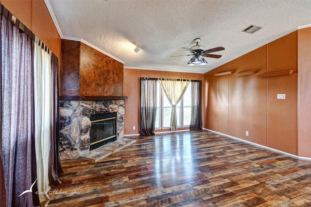 living room with dark hardwood / wood-style floors, a fireplace, ceiling fan, crown molding, and a textured ceiling