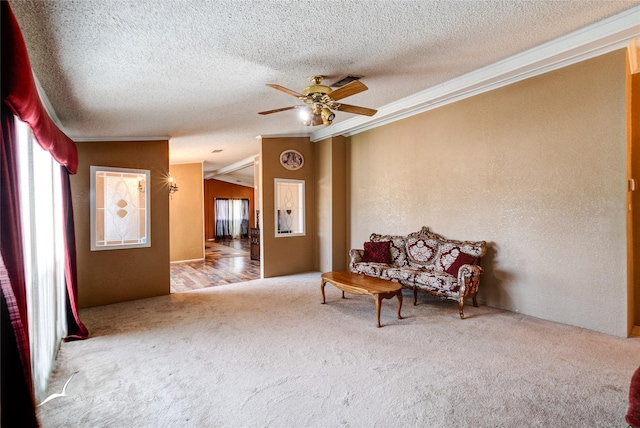 unfurnished room featuring lofted ceiling, carpet flooring, ceiling fan, crown molding, and a textured ceiling