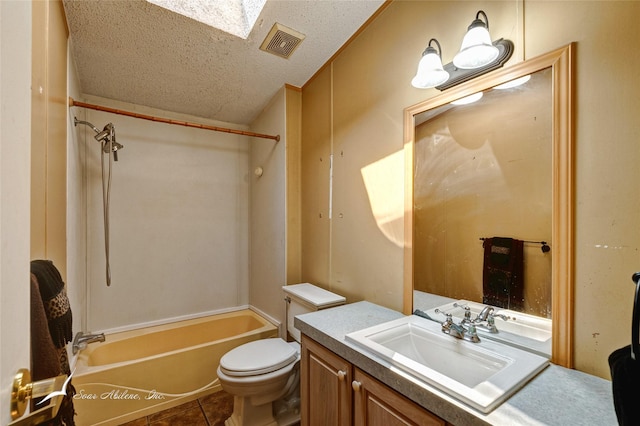 full bathroom with tile patterned floors, toilet, bathing tub / shower combination, a textured ceiling, and vanity