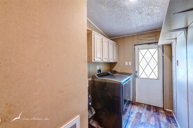 clothes washing area with hookup for a washing machine, dark hardwood / wood-style floors, cabinets, and a textured ceiling