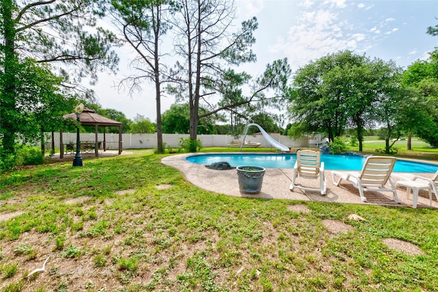 view of pool with a gazebo, a water slide, and a lawn