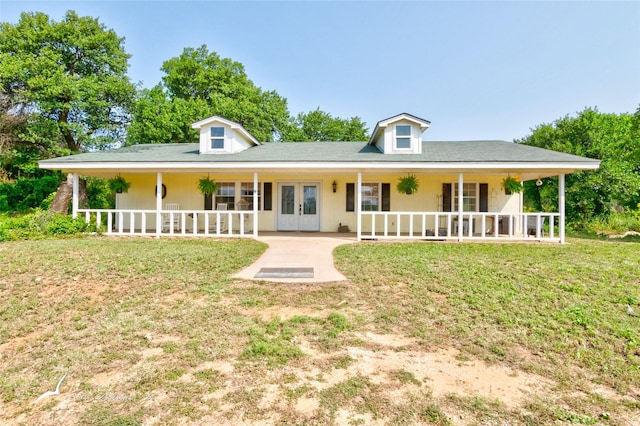 view of front of home featuring a front yard, french doors, and a porch