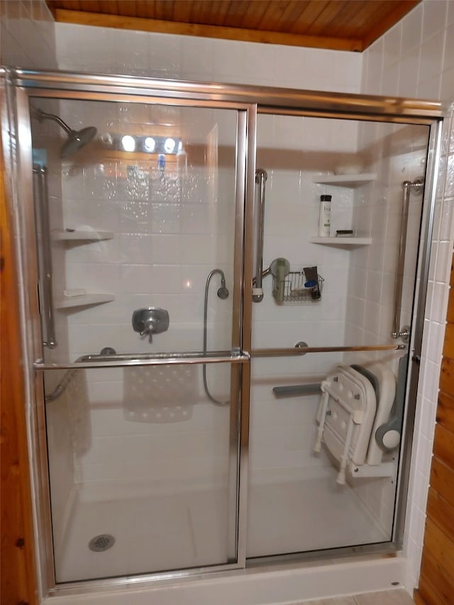 bathroom with wooden ceiling and an enclosed shower