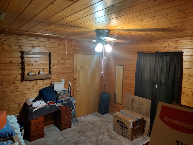 carpeted bedroom featuring wooden walls, ceiling fan, and wood ceiling