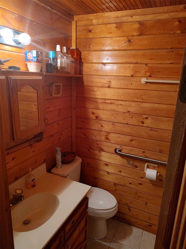 bathroom featuring tile floors, wooden walls, wood ceiling, vanity, and toilet