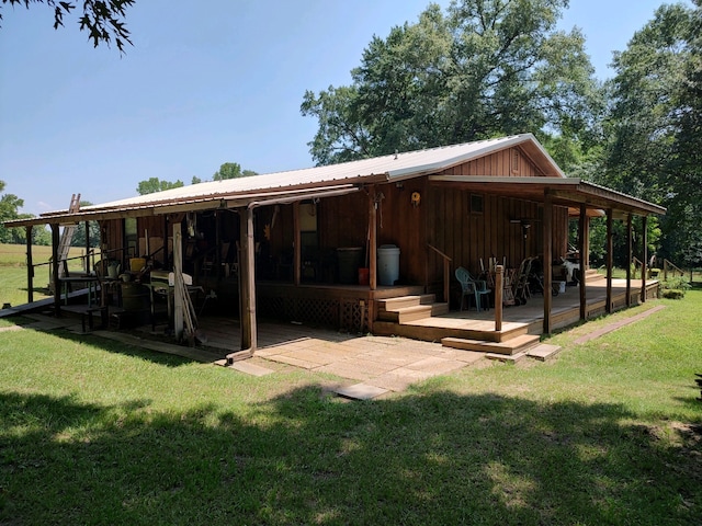 exterior space featuring a lawn and a wooden deck