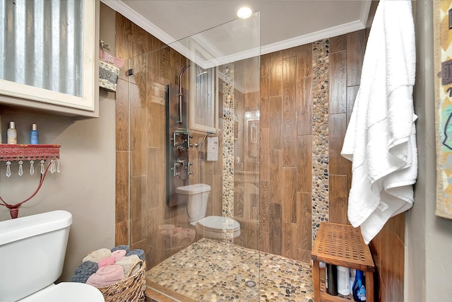 bathroom with toilet, ornamental molding, and walk in shower