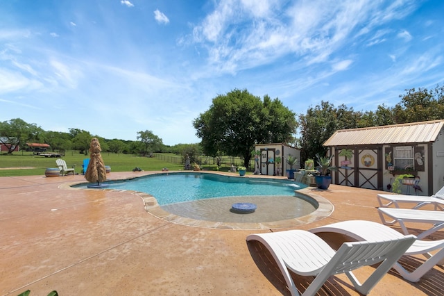 view of swimming pool with an outbuilding, a patio, and a lawn