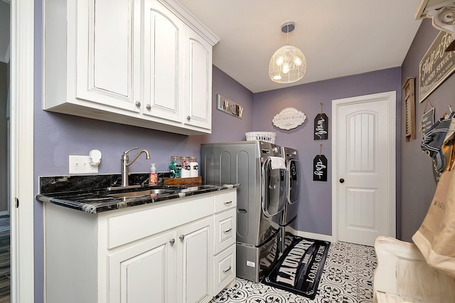 laundry room with separate washer and dryer, sink, light tile patterned floors, and cabinets