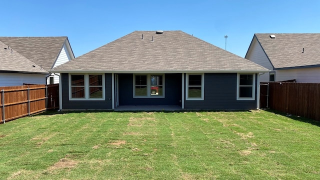 rear view of property with a lawn