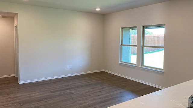 empty room with dark hardwood / wood-style floors