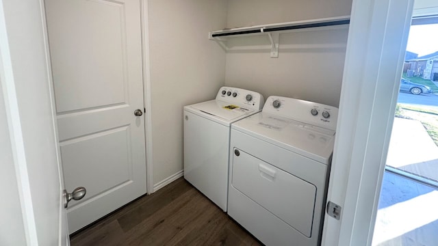 laundry area with dark hardwood / wood-style flooring and washing machine and clothes dryer