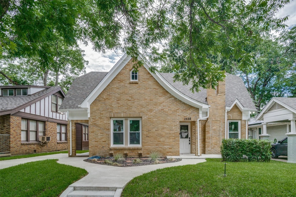 view of front of house with a front lawn and cooling unit