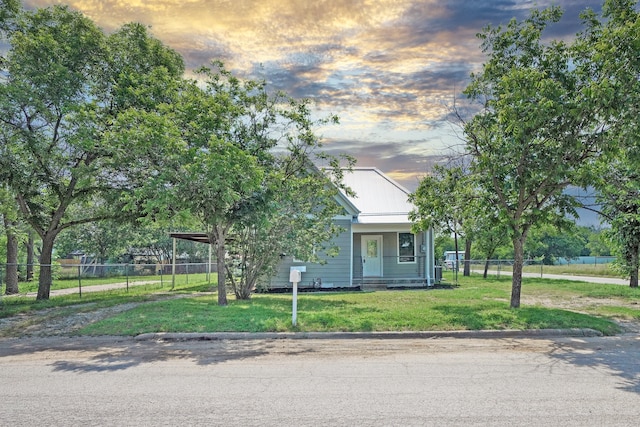 obstructed view of property with a yard and a carport