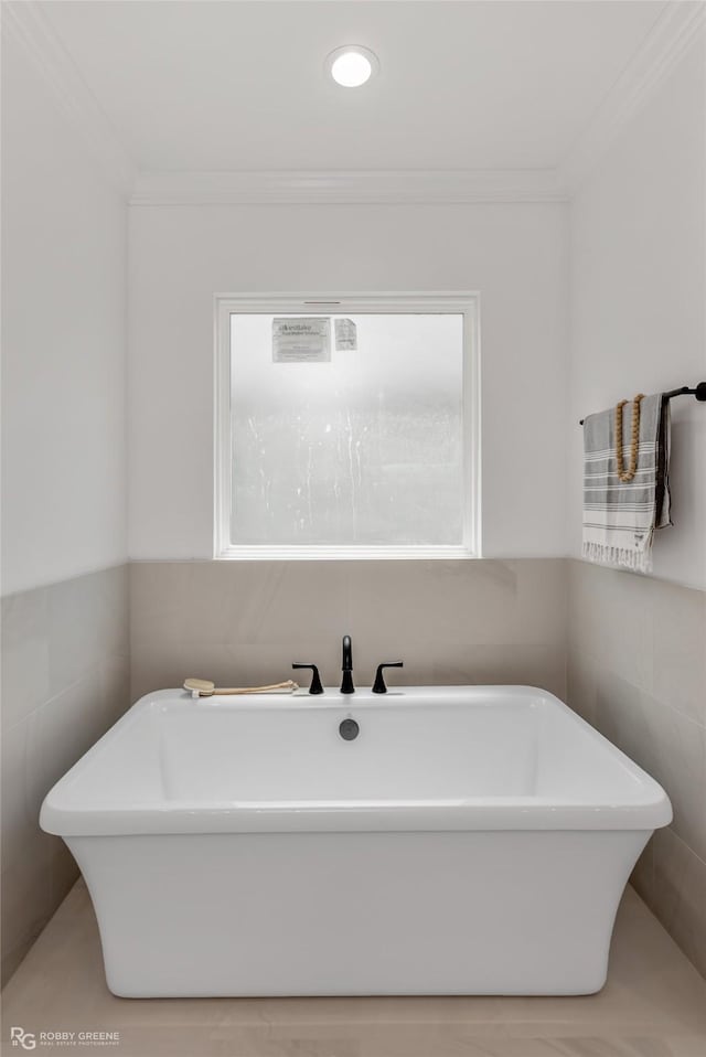 bathroom with a bathtub and ornamental molding