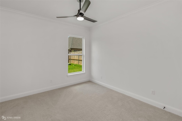 spare room with light colored carpet, ceiling fan, and ornamental molding