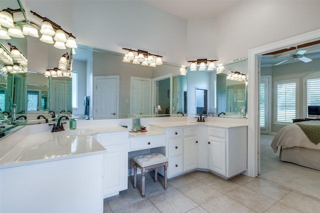 12198 Bell Rd, Pilot Point, TX 76258 - full bathroom with double vanity, ceiling fan, tile patterned floors, connected bathroom, and a high ceiling