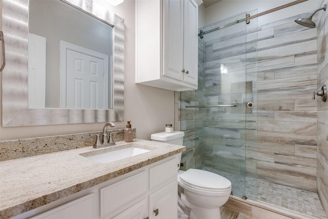 bathroom featuring vanity, toilet, and walk in shower