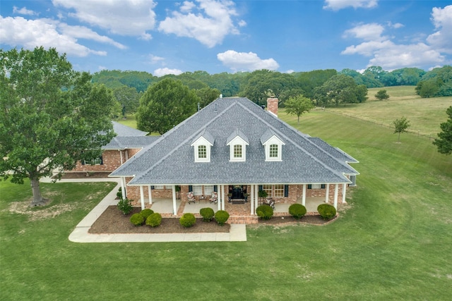 view of front of home featuring a front lawn and a patio