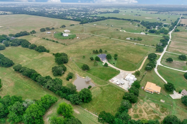 birds eye view of property featuring a rural view and a water view