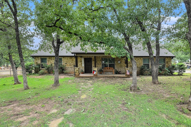 ranch-style house with a porch and a front lawn