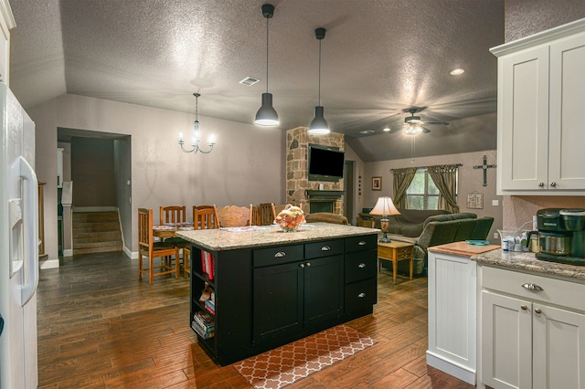 kitchen with white cabinets, dark hardwood / wood-style flooring, and vaulted ceiling