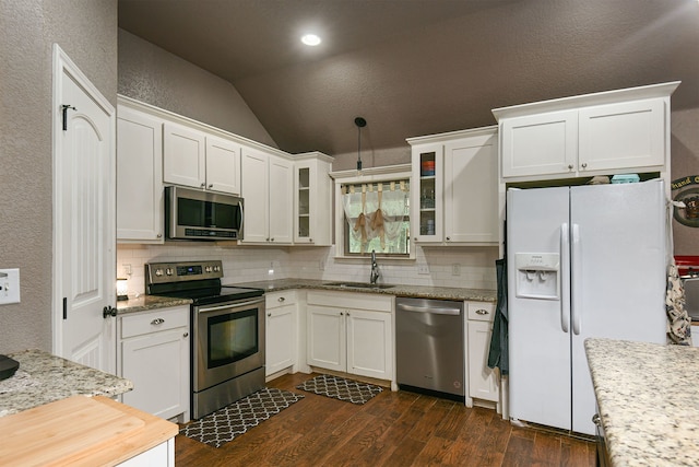 kitchen with stainless steel appliances, white cabinetry, sink, dark hardwood / wood-style floors, and lofted ceiling